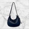 Navy blue handbag on a marble background